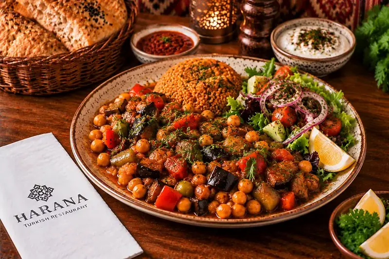 Chickpea and vegetable mix served with bulgur, fresh salad and lemon