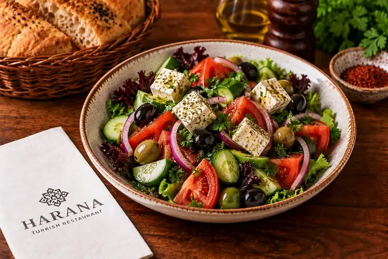 Greek feta salad with tomatoes, cucumber, olives, red onion and fresh herbs