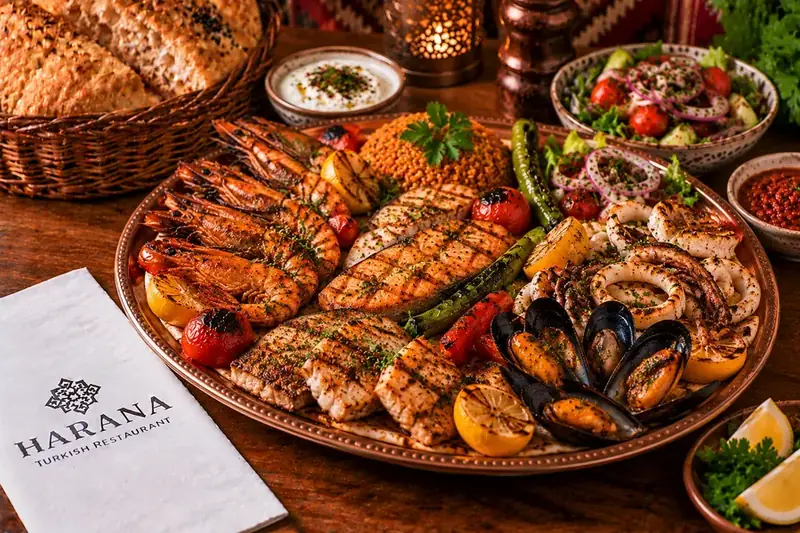 Harana seafood sharing platter with grilled fish, prawns, calamari, mussels, bulgur, salad and grilled vegetables