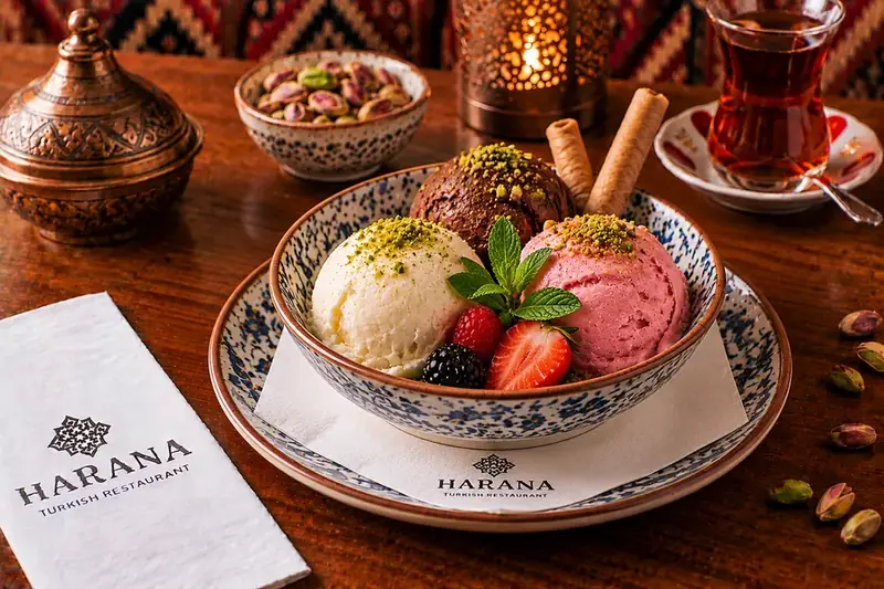 Mixed ice cream with vanilla, chocolate and strawberry scoops, served with fresh berries and wafer rolls