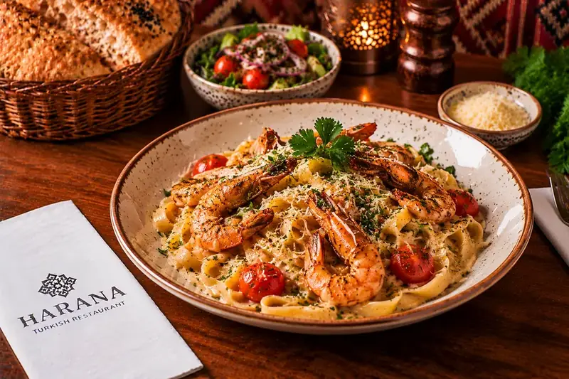 Tagliatelle pasta with prawns, cherry tomatoes, herbs and Parmesan